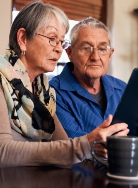 senior couple using a tablet